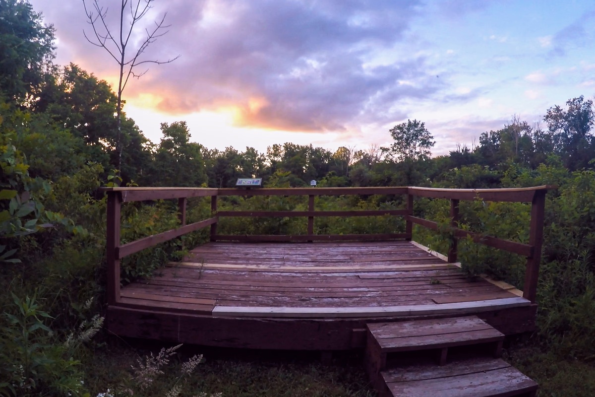 Wooden practice deck surrounded by garden growth at a real SILK Homes property