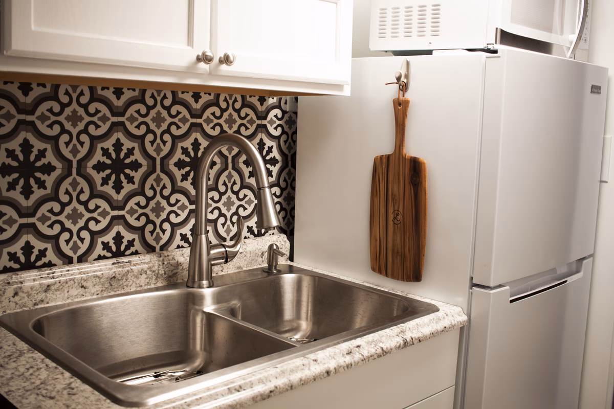 Working kitchen with patterned tile and wood cabinets in a Parkersburg SILK Homes property