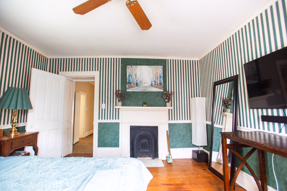 Furnished bedroom with a writing desk and computer nook in a real SILK Homes cottage