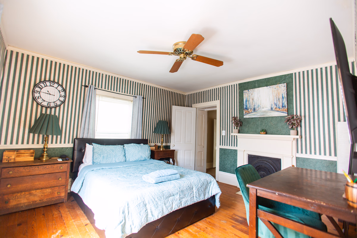 Green-striped furnished bedroom in a real SILK Homes property