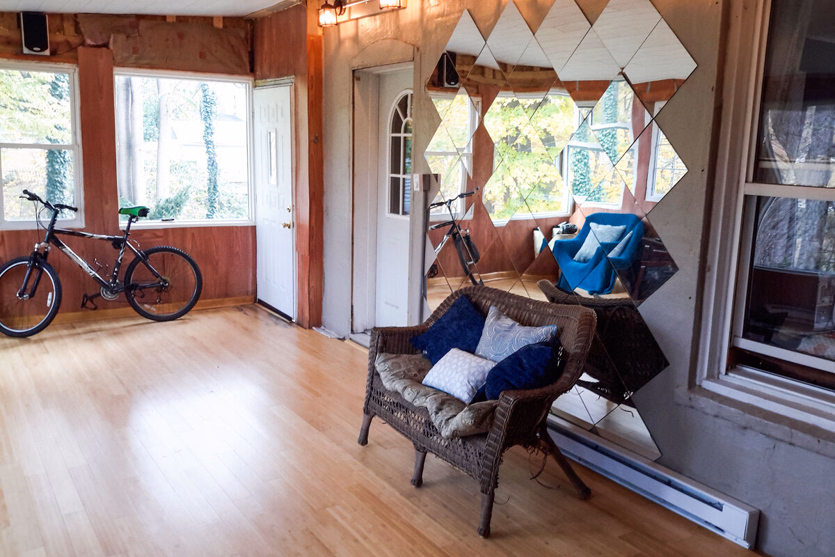 Sunlit shared room with a reading chair and bicycle in a real SILK Homes property