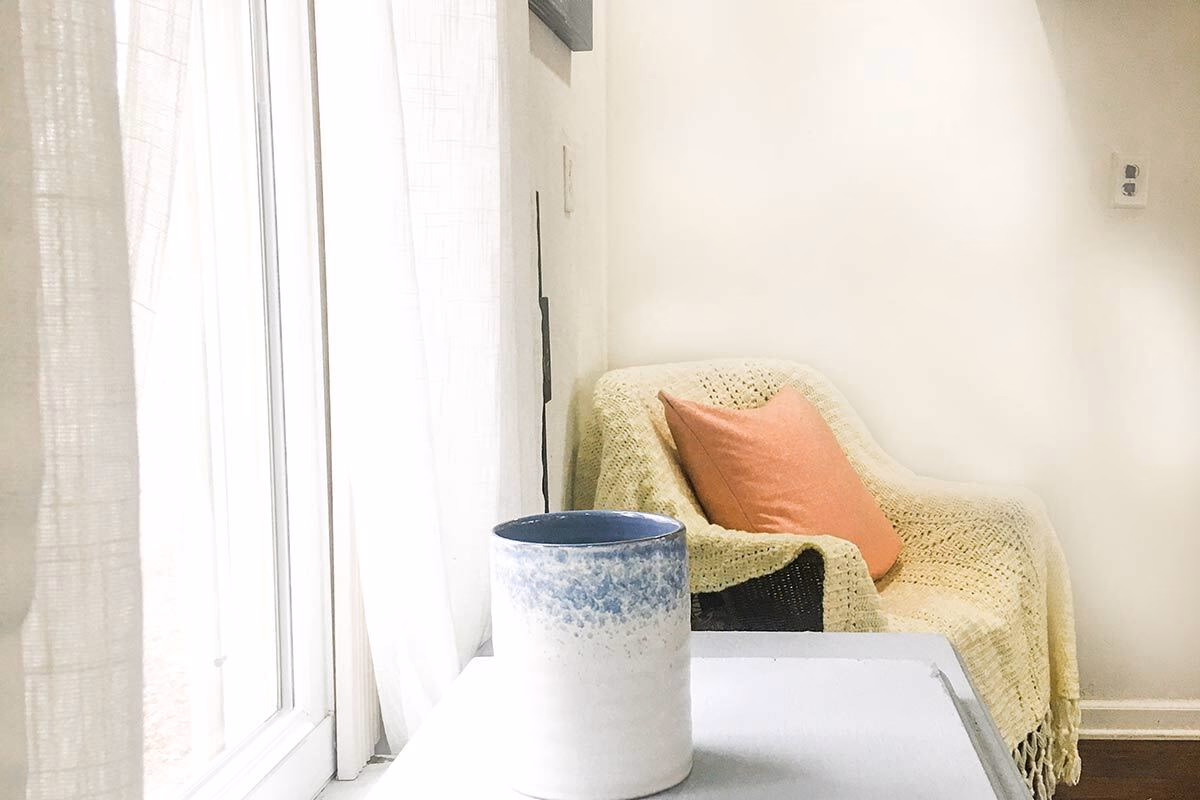 A quiet window-side chair in a real SILK Homes property