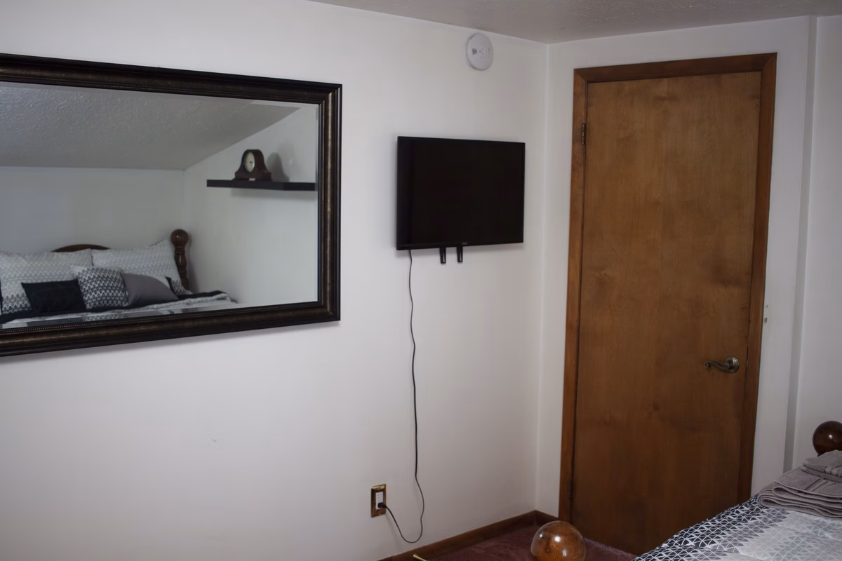 Furnished bedroom and mirror detail in a real SILK Homes property
