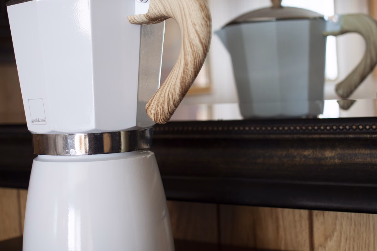 Coffee maker and mugs on a kitchen counter in a real SILK Homes property