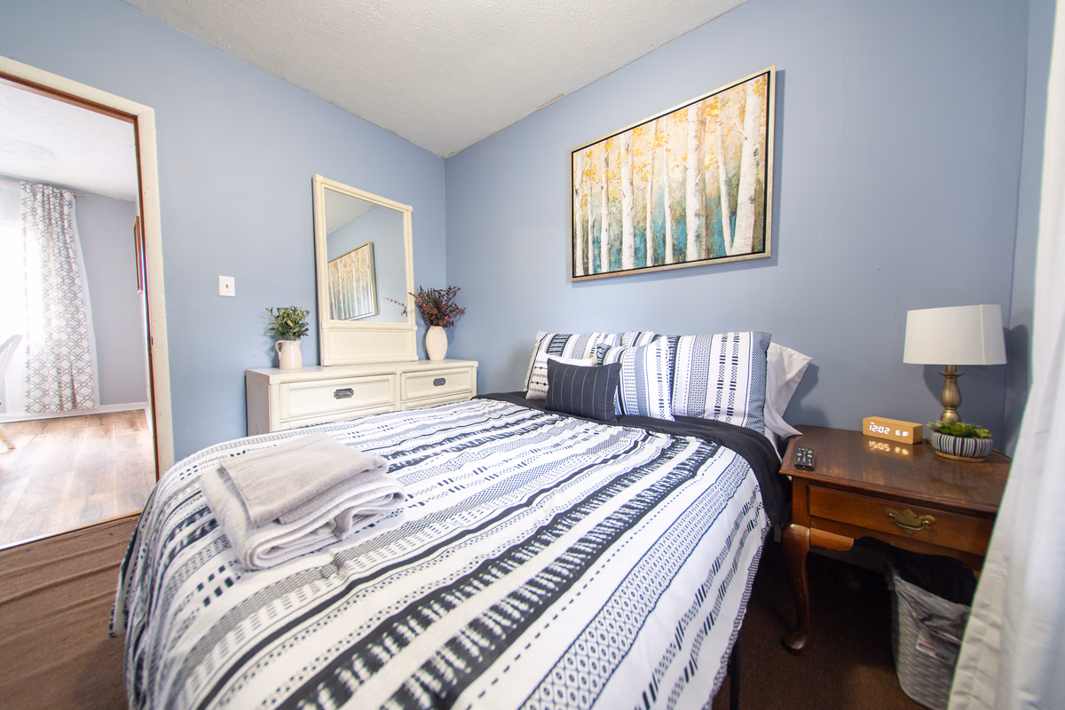 Blue furnished bedroom in a real SILK Homes property