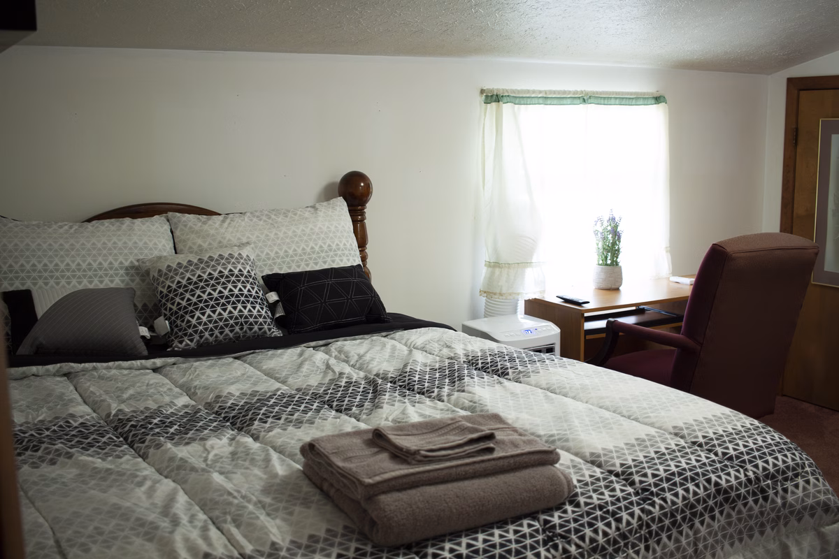 Bright furnished bedroom with a quiet work corner in a real SILK Homes property