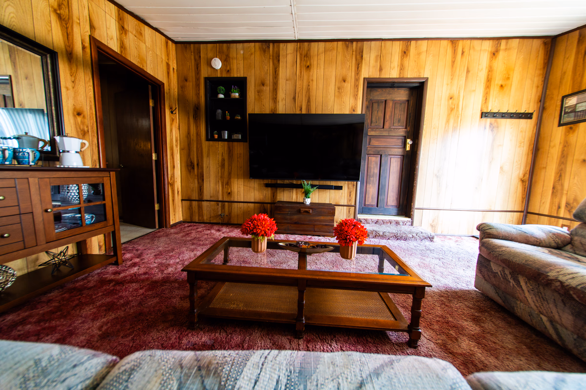 Warm wood-paneled common room in a real SILK Homes property